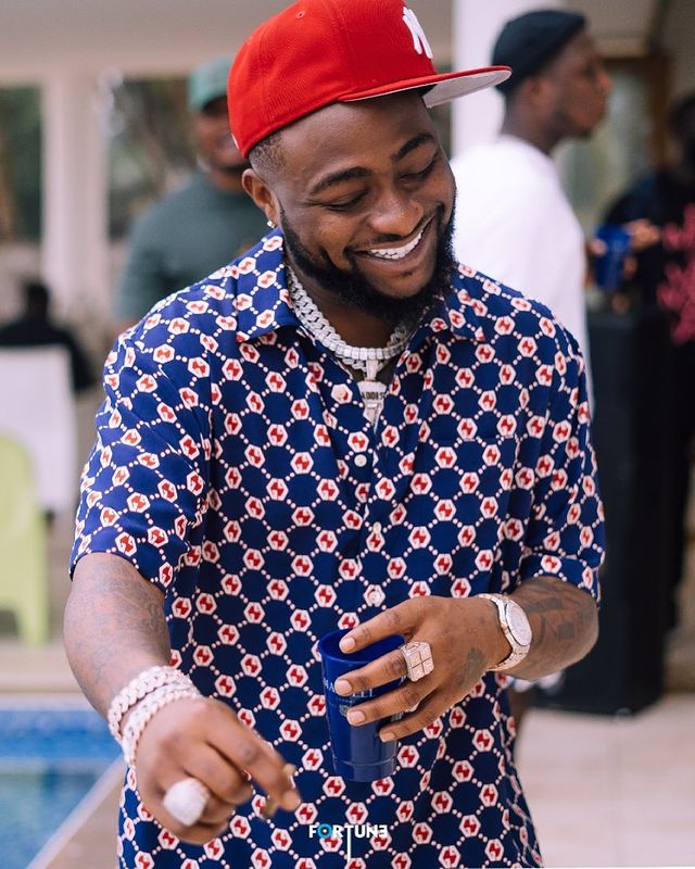 Children at the beach house get an improvised concert by Davido, a musician