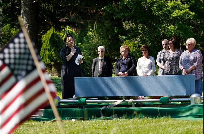 Edwina Frances Martin, Staten Island’s public administrator of estates, left, says a few words during a burial of four people at a cemetery in the Staten Island borough of New York