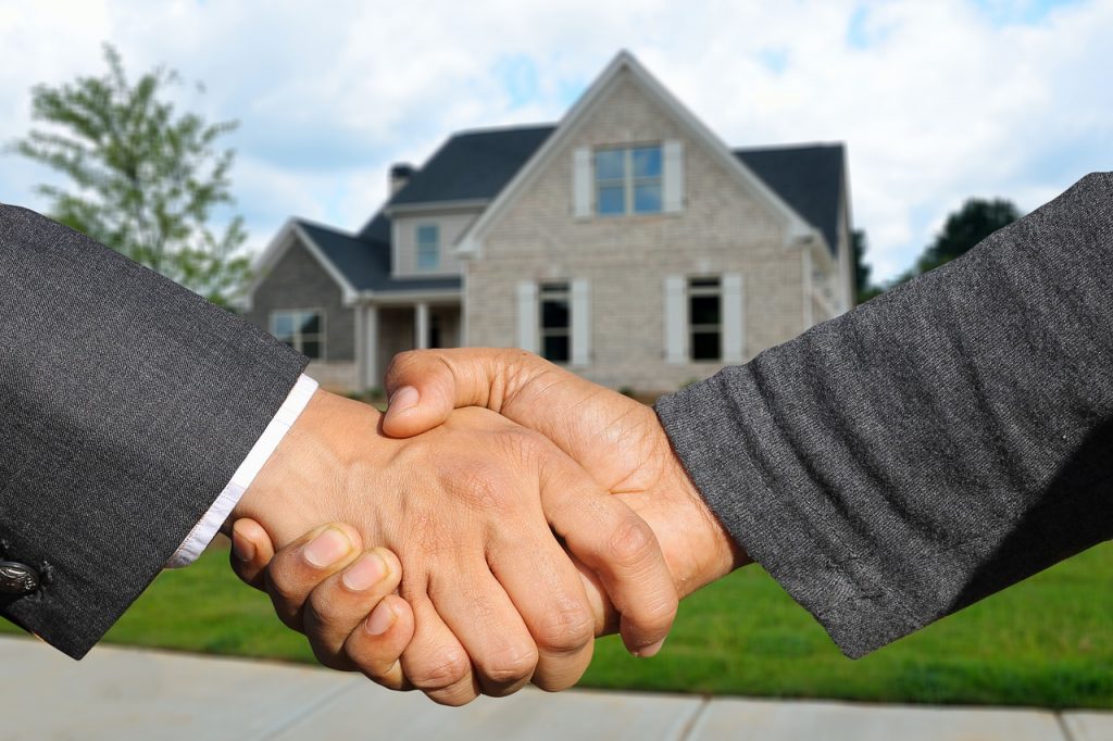 Real estate agent and Property valuation assistance shaking hand