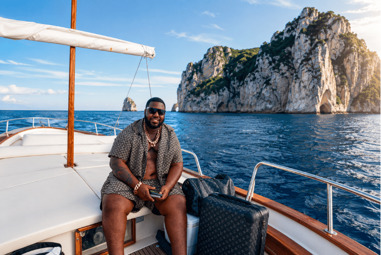 Jeremiah the business tycoon sitting on his own boat exploring the ocean